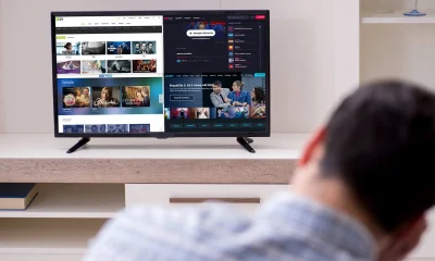 a man looking at a television screen